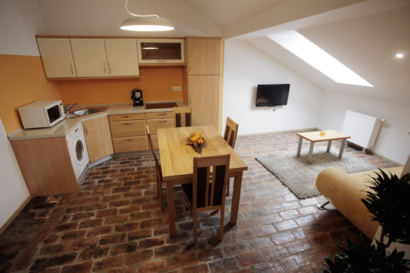 File:Residence Centre Cankarjeva 2026 orange apartment kitchen Archive JSKD.jpg
