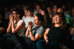 The laughing audience at the international stand-up comedy festival <!--LINK'" 0:325-->, Ljubljana 2022. Author: Jaka Škrlep