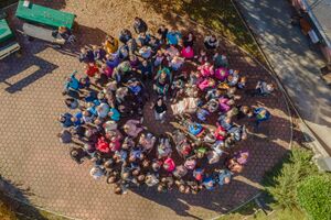 A group photo of Occupational Activity Centre's residents and employees, 2025.