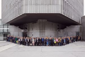 A group portrait of Biennial of Design 2019 participants, standing in front of the <!--LINK'" 0:413--> in Ljubljana