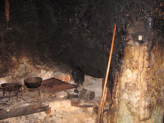 The old kitchen, also called a black kitchen (Črna kuhinja) with an open fireplace and bread oven, Pocar Homestead, Mojstrana