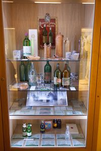 A display cabinet with healing mineral water bottles (the oldest ones made of clay) and old bottle labels. <!--LINK'" 0:230--> at Ana's Mansion, 2012