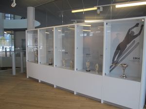 A collection of ski jumping cups exhibited at a the newly established <!--LINK'" 0:6--> in the pavilion of the Nordic Centre Planica, 2016.